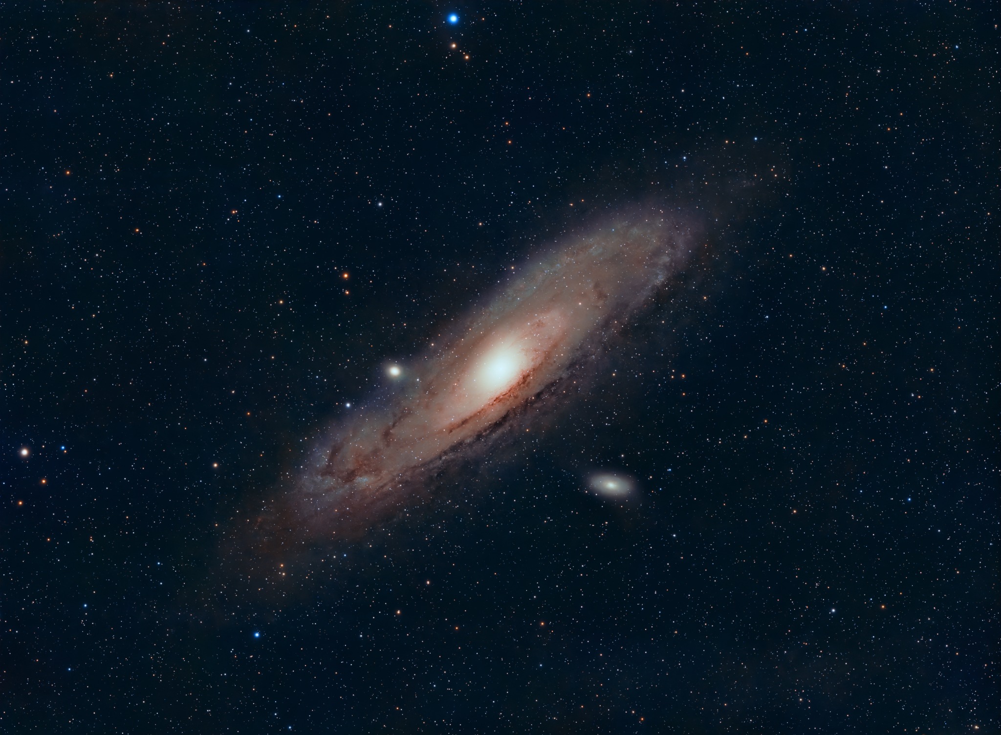 Astrophotograph of the Andromeda Galaxy with its companion galaxies and surrounding star field